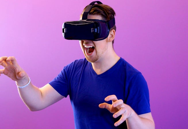 man excitedly using a VR headset